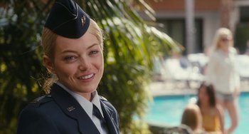 Movie still from “Aloha” (2015), directed by Cameron Crowe – A woman in a military uniform smiling for the camera; Close Up shot, Over the shoulder angle