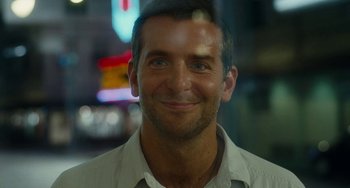 Movie still from “Aloha” (2015), directed by Cameron Crowe – A man smiling for the camera; Close Up shot, Over the shoulder angle