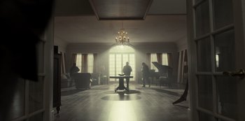 Movie still from “Fargo” (2014), created by Noah Hawley – A group of people sitting around a table in a living room; Extreme Wide shot, Low angle
