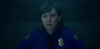 Movie still from “Fargo” (2014), created by Noah Hawley – A woman in a police uniform looking at the camera; Close Up shot, Over the shoulder angle
