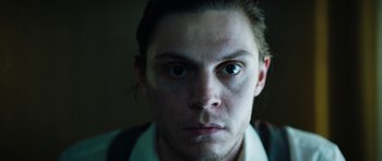 Movie still from “American Animals” (2018), directed by Bart Layton – A person's face in a dark room; Close Up shot, Low angle
