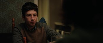 Movie still from “American Animals” (2018), directed by Bart Layton – A man sitting at a table with a glass of wine; Close Up shot, Over the shoulder angle