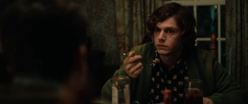 Movie still from “American Animals” (2018), directed by Bart Layton – A man sitting at a table smoking a cigarette in front of a mirror; Close Up shot, Over the shoulder angle
