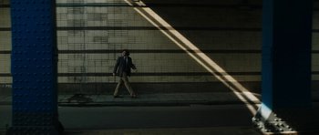 Movie still from “American Animals” (2018), directed by Bart Layton – A man walking down the sidewalk in the dark; Extreme Wide shot, Low angle