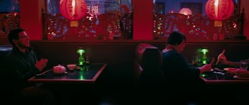 Movie still from “American Animals” (2018), directed by Bart Layton – A person sitting at a table in a restaurant; Wide shot, High angle