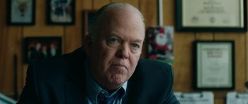 Movie still from “American Animals” (2018), directed by Bart Layton – An older man in a suit and a tie; Close Up shot, Over the shoulder angle