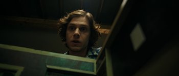Movie still from “American Animals” (2018), directed by Bart Layton – A man with long brown hair looking into a mirror; Close Up shot, Low angle