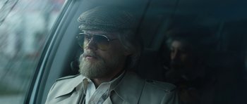 Movie still from “American Animals” (2018), directed by Bart Layton – A man with a beard wearing a hat and sunglasses; Close Up shot, Low angle