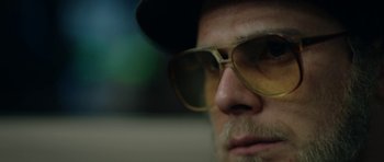 Movie still from “American Animals” (2018), directed by Bart Layton – A person wearing a hat and sunglasses; Extreme Close Up shot, Low angle