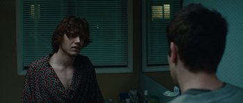 Movie still from “American Animals” (2018), directed by Bart Layton – Two people are talking in front of a mirror; Medium shot, Over the shoulder angle