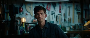 Movie still from “American Animals” (2018), directed by Bart Layton – A man standing in front of a wall of tools; Close Up shot, Low angle
