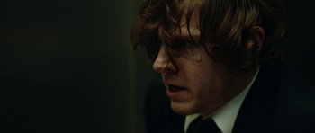 Movie still from “American Animals” (2018), directed by Bart Layton – A person wearing a suit and tie; Close Up shot, Over the shoulder angle