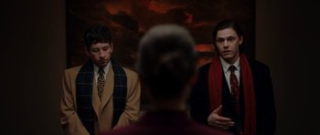 Movie still from “American Animals” (2018), directed by Bart Layton – Two men standing in front of another man in front of a sky background; Medium shot, Over the shoulder angle