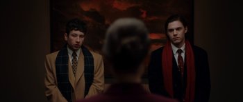 Movie still from “American Animals” (2018), directed by Bart Layton – Two men in suits and scarfs standing next to each other in front of a painting; Medium shot, Over the shoulder angle
