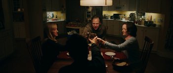 Movie still from “American Animals” (2018), directed by Bart Layton – A group of people sitting at a table drinking wine; Medium shot, Over the shoulder angle