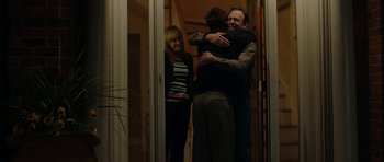 Movie still from “American Animals” (2018), directed by Bart Layton – A group of people hugging each other in a room; Medium shot, Over the shoulder angle
