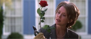 Movie still from “American Beauty” (1999), directed by Sam Mendes – A woman holding a red rose in her hand; Close Up shot, Low angle