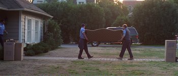 Movie still from “American Beauty” (1999), directed by Sam Mendes – A couple of men walking down a sidewalk near a truck; Wide shot, High angle