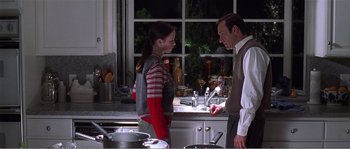 Movie still from “American Beauty” (1999), directed by Sam Mendes – A man and a woman standing in front of a kitchen sink; Medium shot, Over the shoulder angle