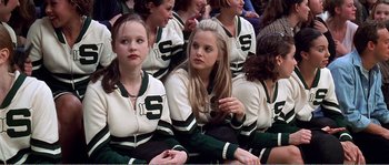 Movie still from “American Beauty” (1999), directed by Sam Mendes – A group of young women sitting in a row; Medium shot, High angle