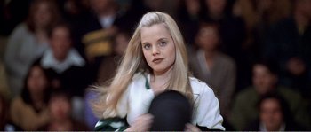 Movie still from “American Beauty” (1999), directed by Sam Mendes – A woman with long blonde hair is holding a hat; Close Up shot, Low angle