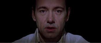 Movie still from “American Beauty” (1999), directed by Sam Mendes – A man's face in the dark; Close Up shot, High angle