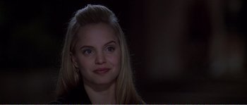 Movie still from “American Beauty” (1999), directed by Sam Mendes – A beautiful young woman with blonde hair and blue eyes; Close Up shot, Over the shoulder angle