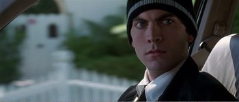 Movie still from “American Beauty” (1999), directed by Sam Mendes – A person wearing a suit and tie; Close Up shot, Low angle