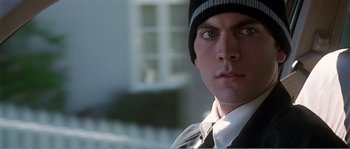 Movie still from “American Beauty” (1999), directed by Sam Mendes – A person wearing a suit and tie; Close Up shot, Low angle