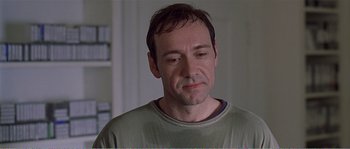 Movie still from “American Beauty” (1999), directed by Sam Mendes – A person with his eyes closed; Close Up shot, Over the shoulder angle