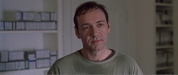 Movie still from “American Beauty” (1999), directed by Sam Mendes – A person wearing a green shirt; Close Up shot, Over the shoulder angle