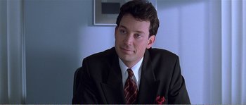 Movie still from “American Beauty” (1999), directed by Sam Mendes – A person wearing a suit and tie; Close Up shot, Over the shoulder angle