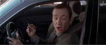 Movie still from “American Beauty” (1999), directed by Sam Mendes – A man sitting in the driver's seat of a car with his eyes closed; Close Up shot, Low angle
