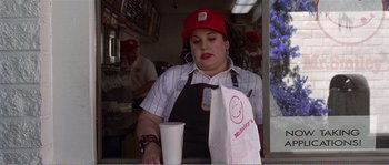 Movie still from “American Beauty” (1999), directed by Sam Mendes – A woman sitting at the counter of a fast - food restaurant; Medium shot, Over the shoulder angle