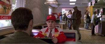 Movie still from “American Beauty” (1999), directed by Sam Mendes – A man sitting at a table in front of another man; Medium shot, Over the shoulder angle