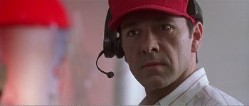 Movie still from “American Beauty” (1999), directed by Sam Mendes – A person wearing headphones and a red hat; Close Up shot, Low angle