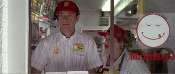 Movie still from “American Beauty” (1999), directed by Sam Mendes – A man and a woman wearing a red hat; Medium shot, Over the shoulder angle