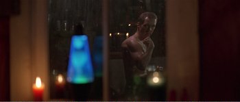 Movie still from “American Beauty” (1999), directed by Sam Mendes – A man standing in front of a window at night; Medium shot, Over the shoulder angle