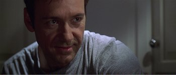 Movie still from “American Beauty” (1999), directed by Sam Mendes – A man's face in a gray shirt; Close Up shot, Over the shoulder angle