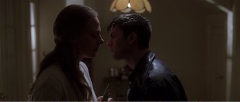 Movie still from “American Beauty” (1999), directed by Sam Mendes – A man and a woman face to face in a dark room; Close Up shot, Low angle