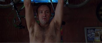 Movie still from “American Beauty” (1999), directed by Sam Mendes – A man with a hairy armpit hanging from a bar; Close Up shot, Low angle