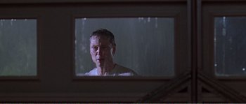 Movie still from “American Beauty” (1999), directed by Sam Mendes – A reflection of a man in a mirror; Close Up shot, Low angle