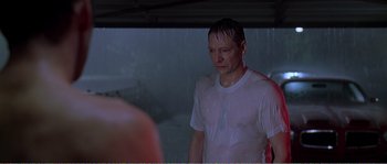 Movie still from “American Beauty” (1999), directed by Sam Mendes – A man in white shirt standing in front of a mirror; Medium shot, Over the shoulder angle