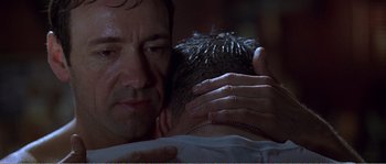 Movie still from “American Beauty” (1999), directed by Sam Mendes – A person with their hands on a mans chest; Close Up shot, Low angle