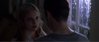 Movie still from “American Beauty” (1999), directed by Sam Mendes – A man and a woman looking at one another; Close Up shot, Over the shoulder angle