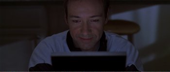 Movie still from “American Beauty” (1999), directed by Sam Mendes – A person using a laptop computer; Close Up shot, Overhead angle