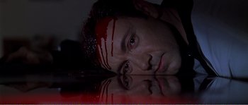 Movie still from “American Beauty” (1999), directed by Sam Mendes – A man laying on the ground with blood all over his face; Close Up shot, Low angle