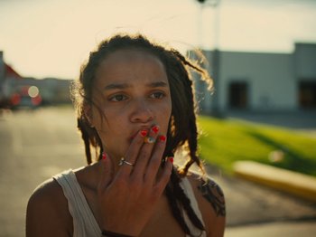 Movie still from “American Honey” (2016), directed by Andrea Arnold – A woman with dreads smoking a cigarette on the side of the road; Close Up shot, Low angle