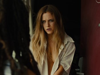 Movie still from “American Honey” (2016), directed by Andrea Arnold – A beautiful young woman with long hair wearing a white shirt; Close Up shot, Over the shoulder angle