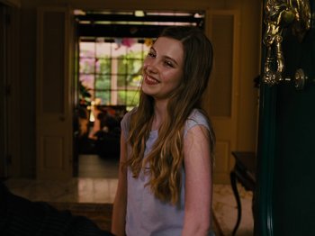 Movie still from “American Honey” (2016), directed by Andrea Arnold – A woman standing next to a doorway in a house; Medium shot, Over the shoulder angle